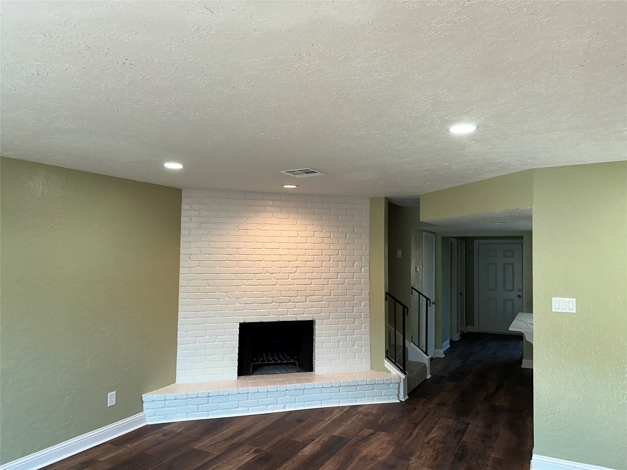 14663 Perthshire Road, Unit 14663 Houston, TX 77079 - Photo 4 of 35 an empty room with wooden floor and fireplace