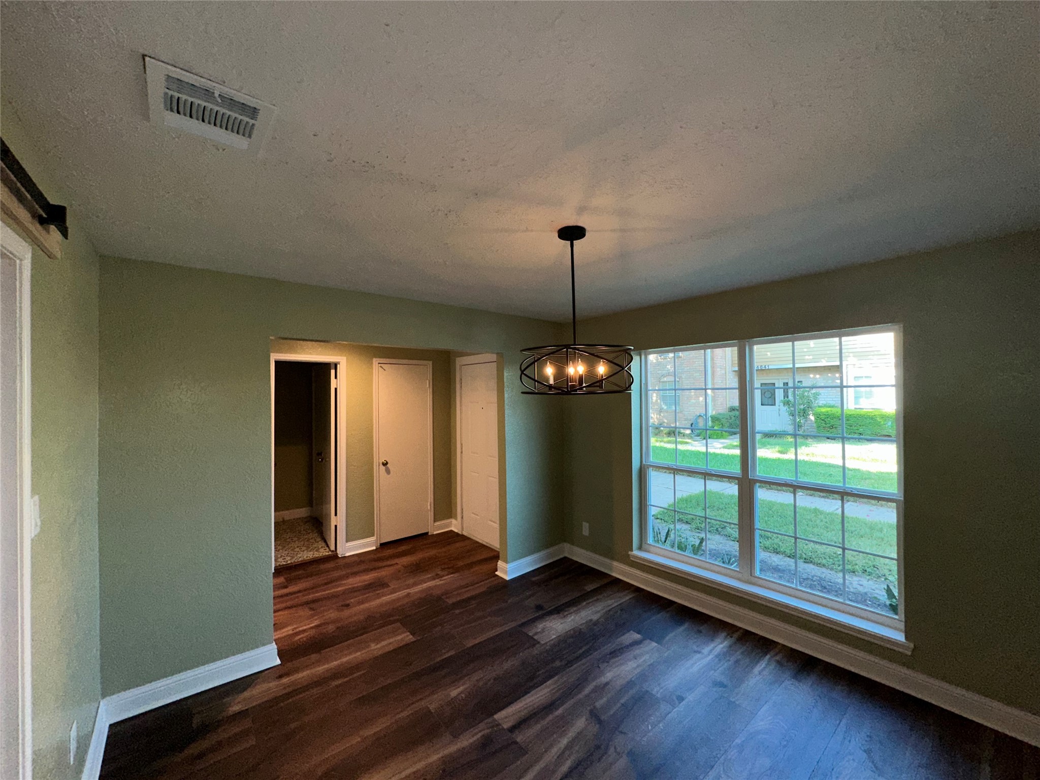 14663 Perthshire Road, Unit 14663 Houston, TX 77079 - Photo 7 of 35 a view of an empty room with wooden floor and a window