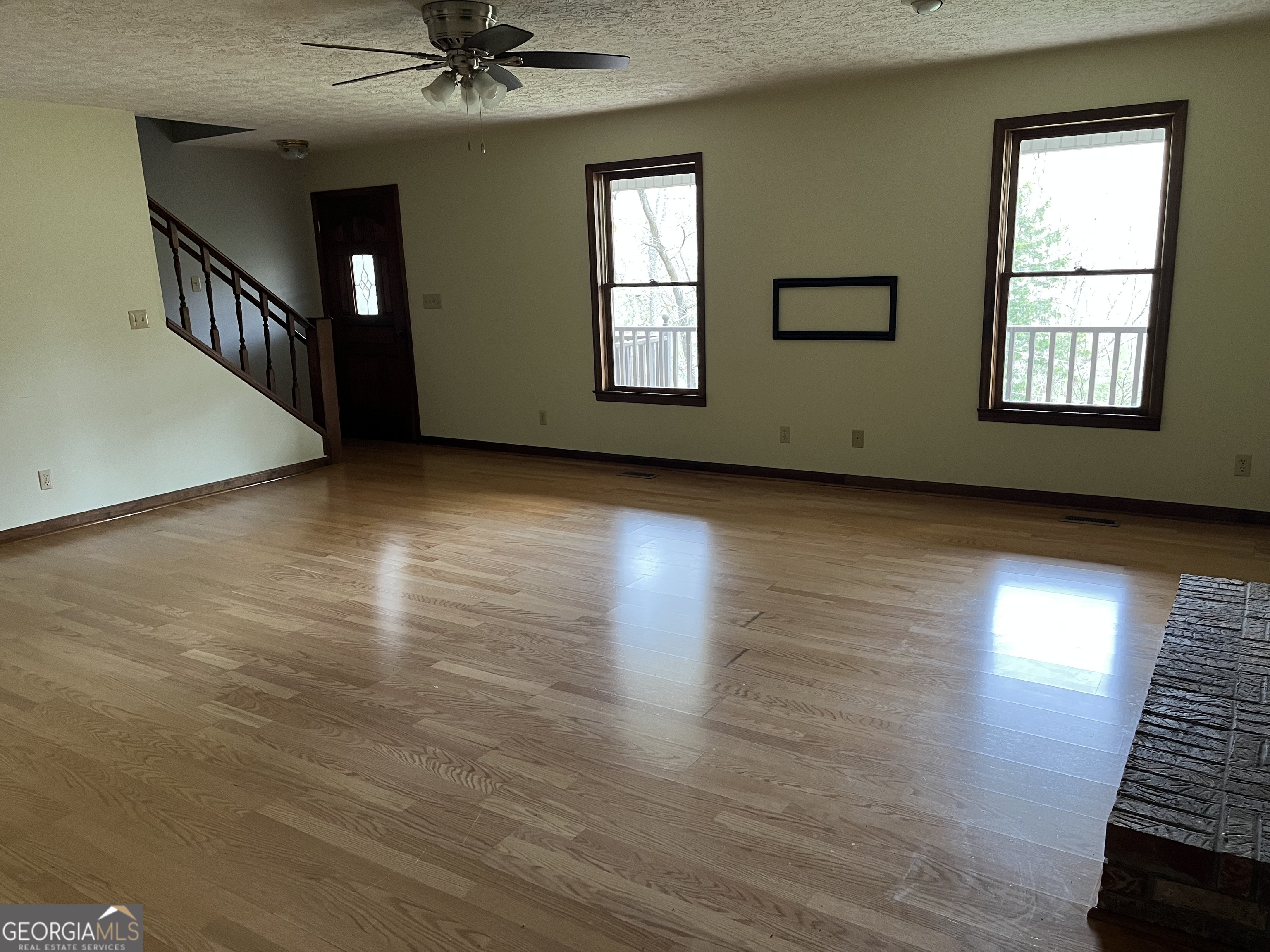 475 Davis Road Southwest Cave Spring, GA 30124 - Photo 18 of 27 an empty room with wooden floor fan and windows