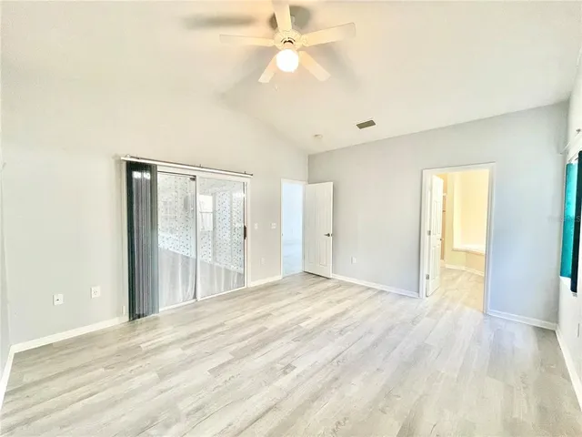 a spacious bathroom with a tub sink and mirror