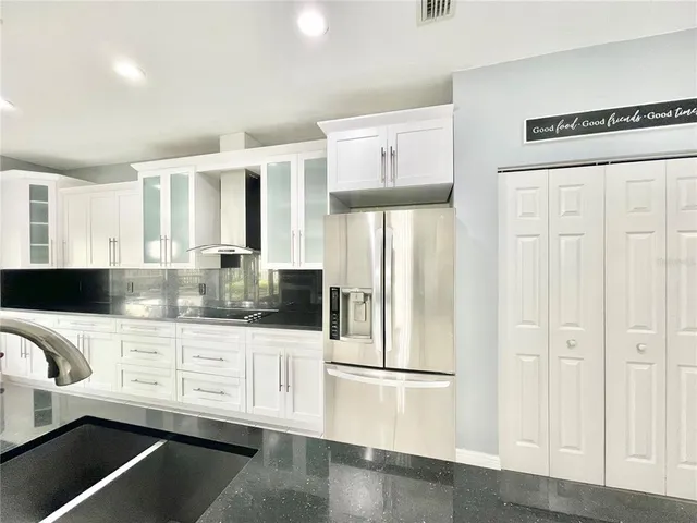a kitchen with stainless steel appliances a refrigerator and a sink