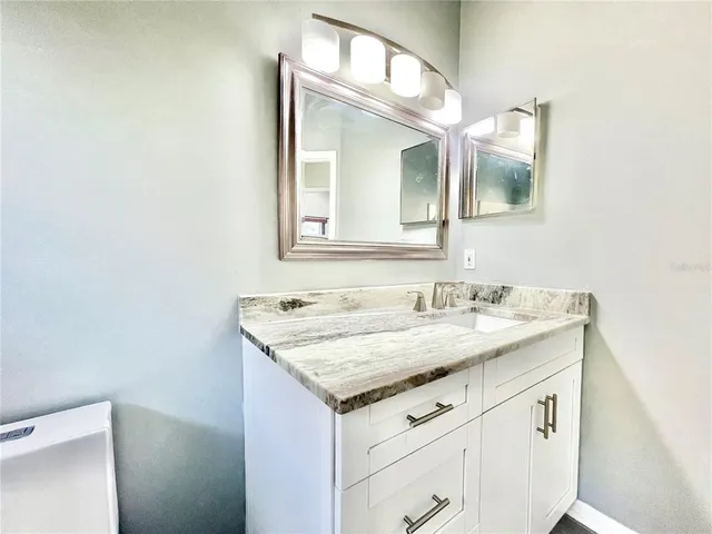 an empty room with closet and fan