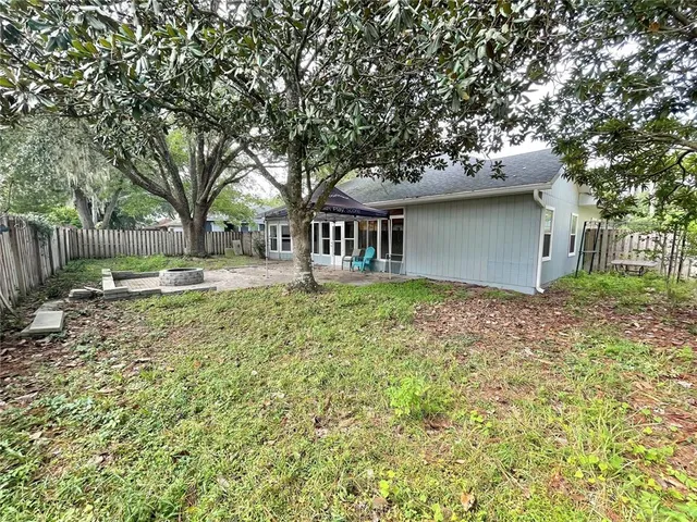 a view of backyard with swimming pool and green space
