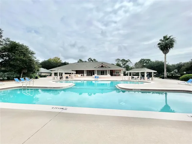 a dining room with furniture and a floor to ceiling window