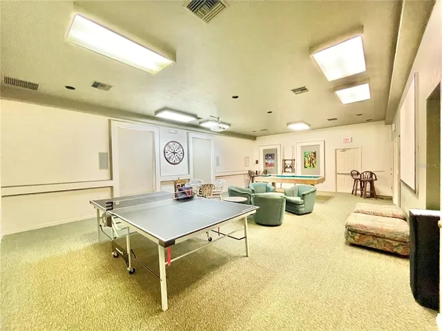 a view of a dining hall with lots of furniture and a large window