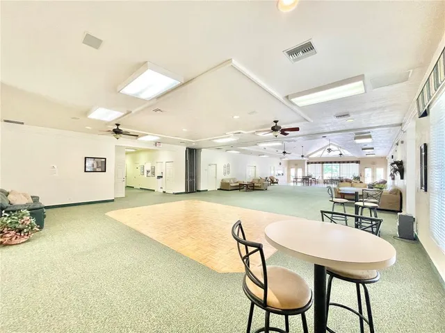 a front view of a house with a swimming pool a yard and a garden