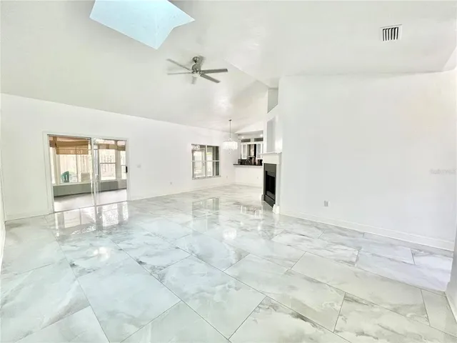 a view of an empty room with a fireplace