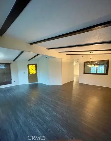 a view of a hallway with wooden floor and a fireplace