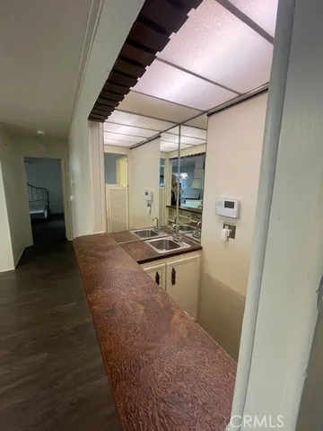 a kitchen with sink and refrigerator