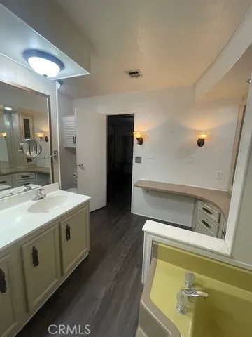a view of a bathroom with a sink and mirror