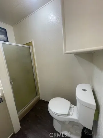 a white toilet sitting next to a small sink