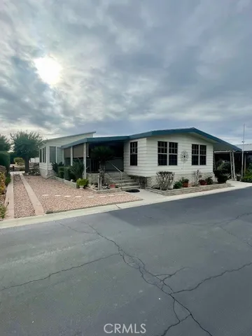a group of people sitting in front of house