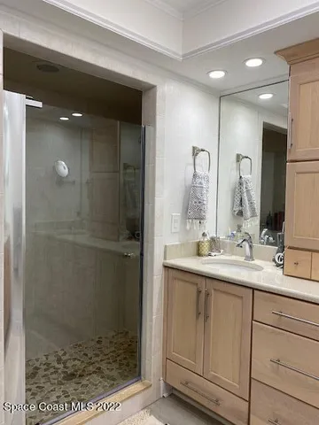 a bathroom with a shower sink and mirror
