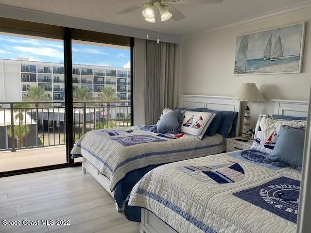 a bedroom with a bed and glass window