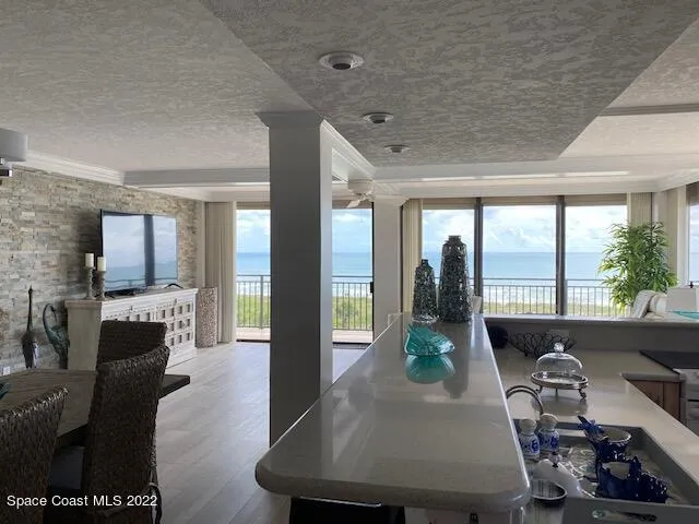 a living room with furniture and large windows