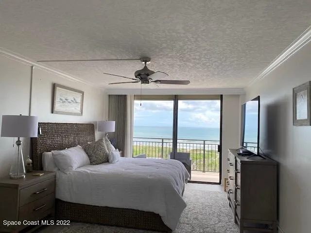 a bedroom with a large bed and a large window