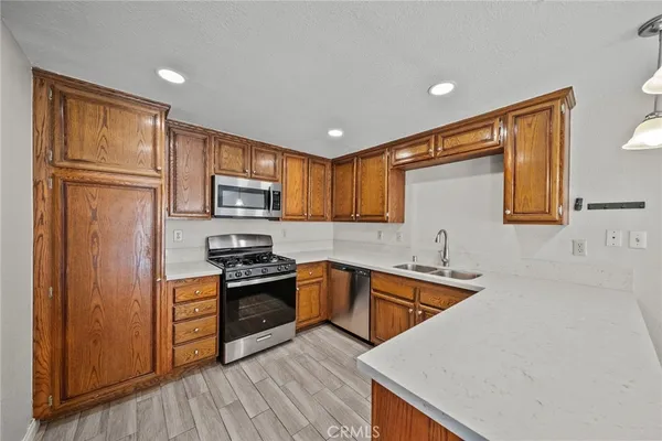 a kitchen with granite countertop stainless steel appliances cabinets a sink and a counter space