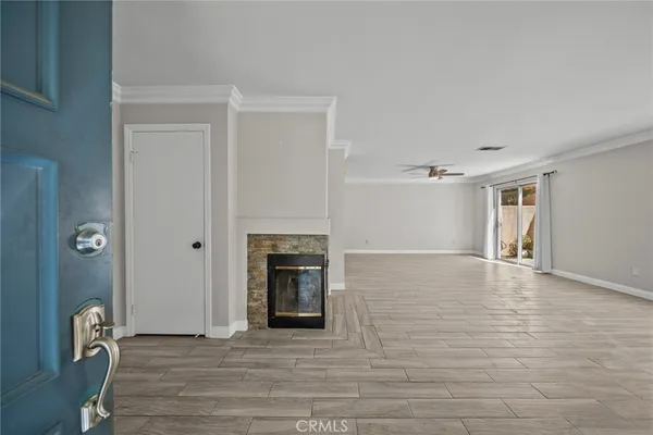 a view of empty room with wooden floor and fireplace