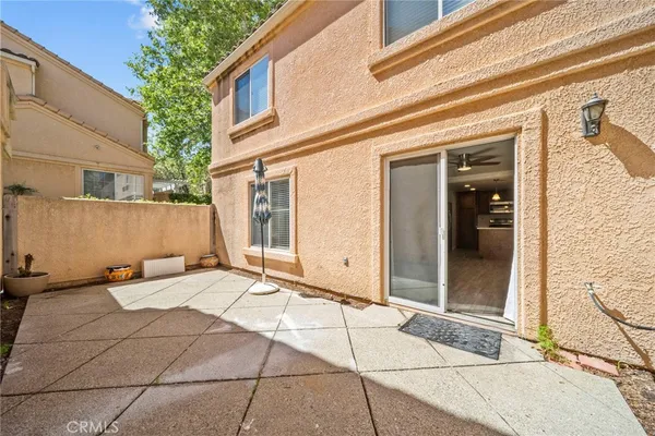 a view of a brick house with an outdoor space