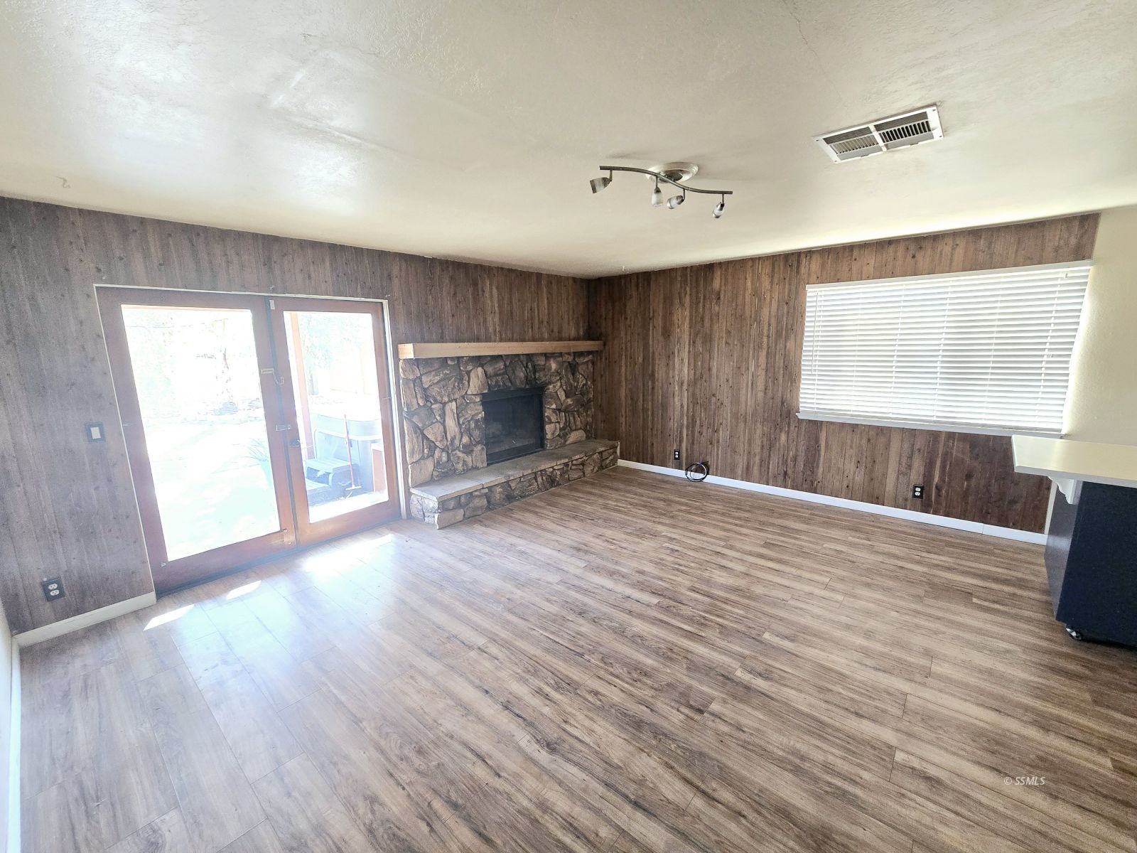 220 South Broadway Street Ridgecrest, CA 93555 - Photo 3 of 11 wooden floor in an empty room with a window