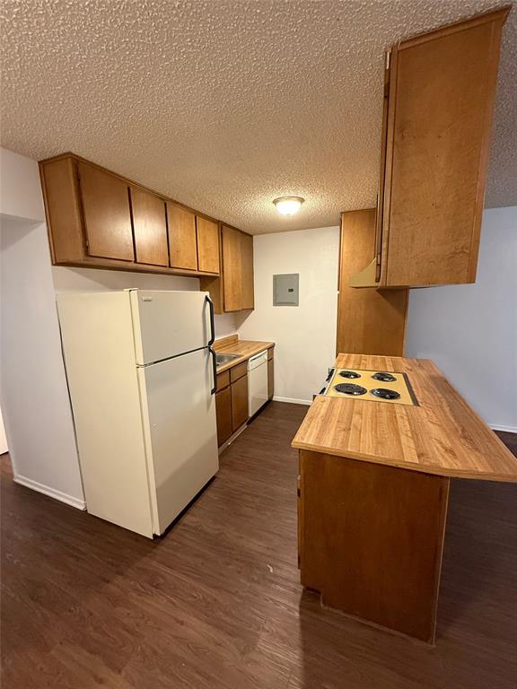 1708 Short Street, Unit B Cleburne, TX 76033 - Photo 3 of 8 Kitchen featuring wood-finish flooring, wood cabinetry, and laminate countertops