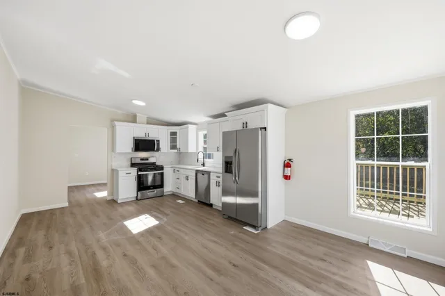 a view of a kitchen with furniture and a window