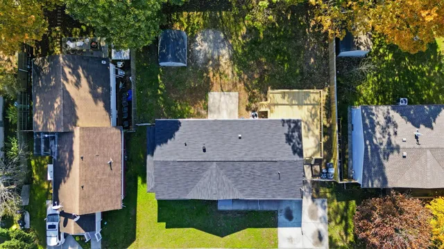 an aerial view of a house with a swimming pool