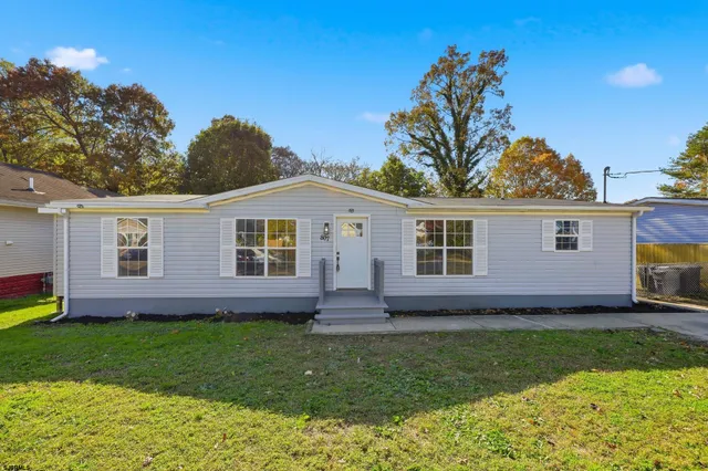 a view of a house with a backyard