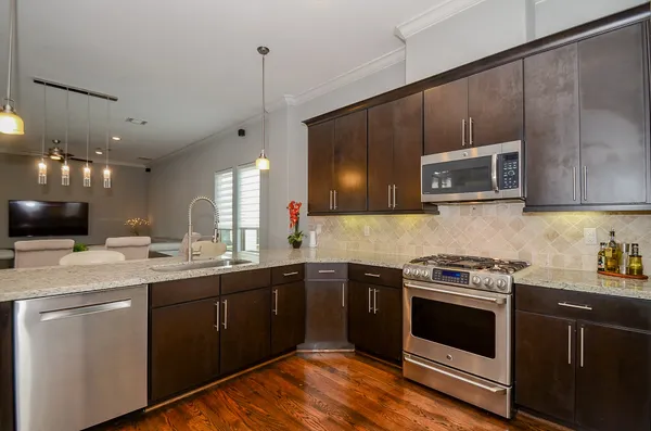 a kitchen with a sink stove and microwave