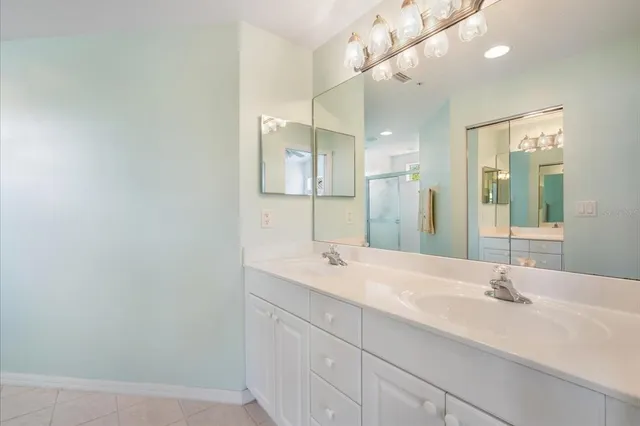 a bathroom with a sink vanity and a mirror