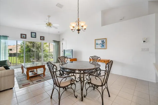 a view of a dining room with furniture a chandelier and wooden floor