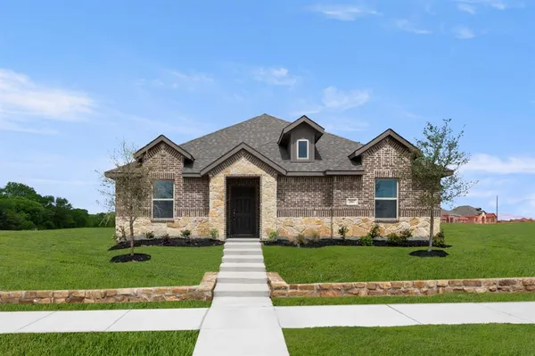 a front view of a house with a yard