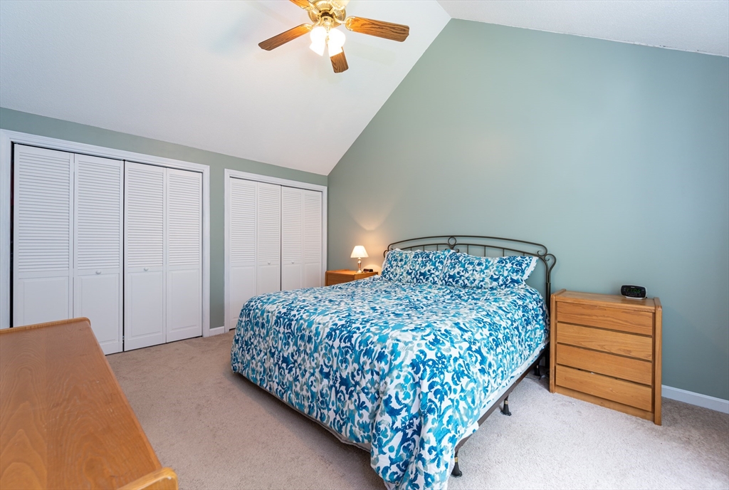 11 Emerson Road Nashua, NH 03062 - Photo 15 of 35 a bedroom with a bed and a chandelier