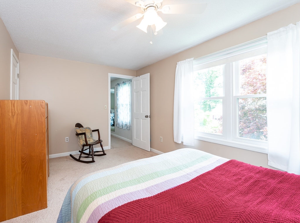 11 Emerson Road Nashua, NH 03062 - Photo 21 of 35 a bedroom with a bed a chair and a window