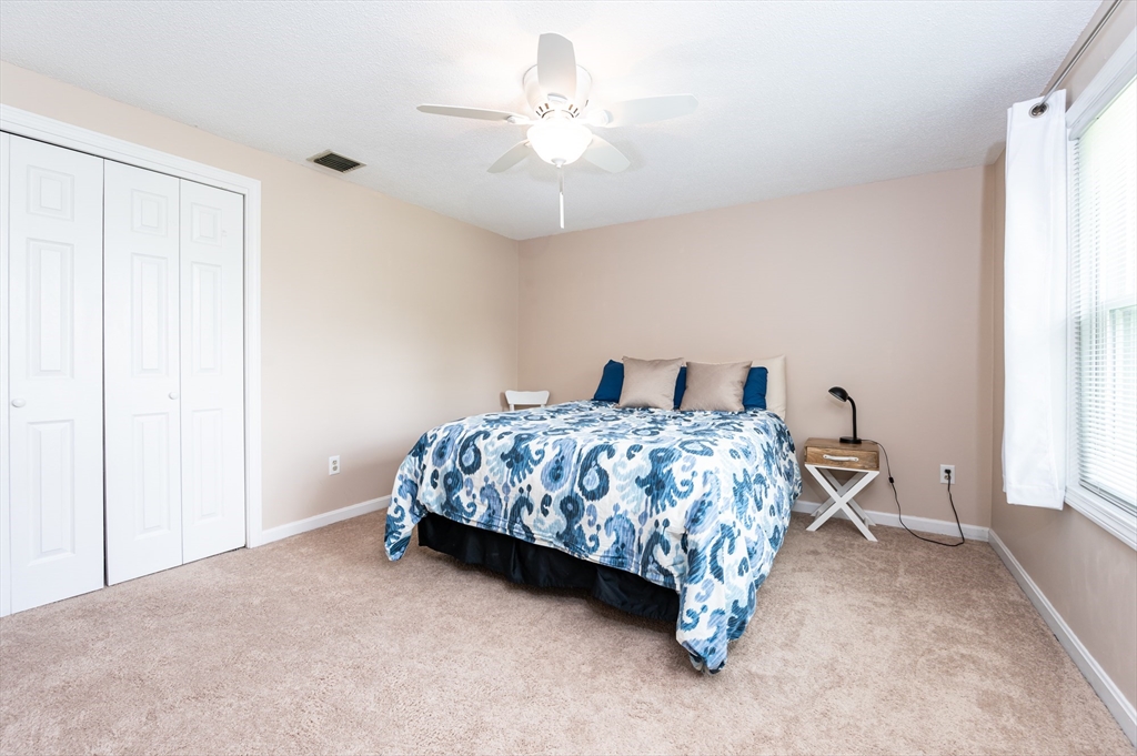 11 Emerson Road Nashua, NH 03062 - Photo 22 of 35 a bedroom with a bed and a chandelier
