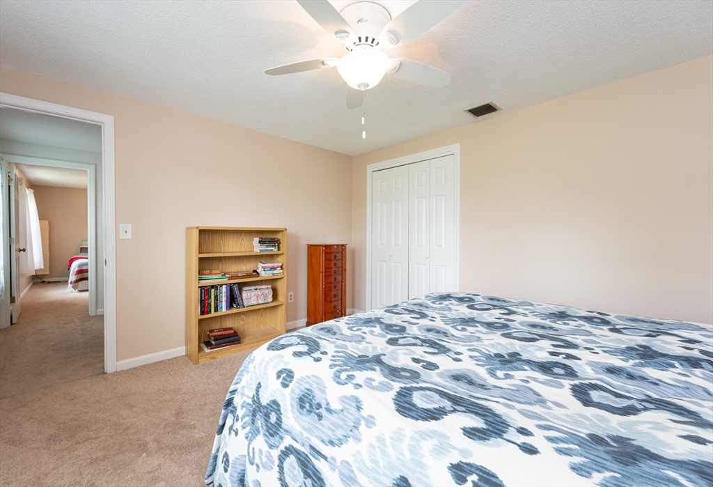 11 Emerson Road Nashua, NH 03062 - Photo 23 of 35 a bedroom with a bed and a chandelier