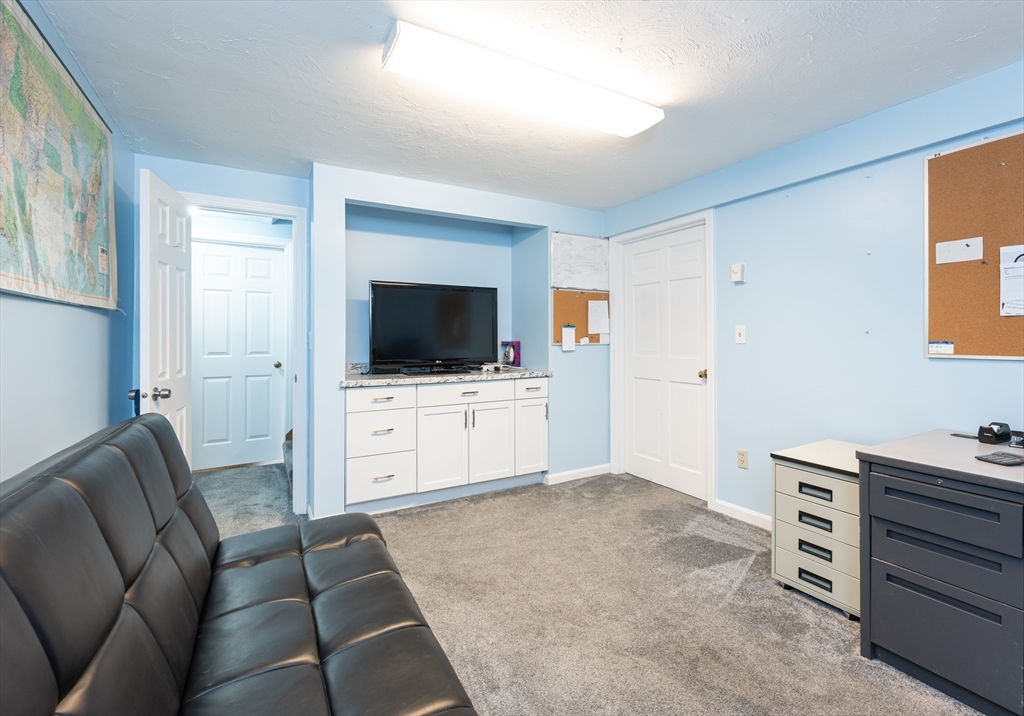 11 Emerson Road Nashua, NH 03062 - Photo 27 of 35 a living room with furniture and a flat screen tv