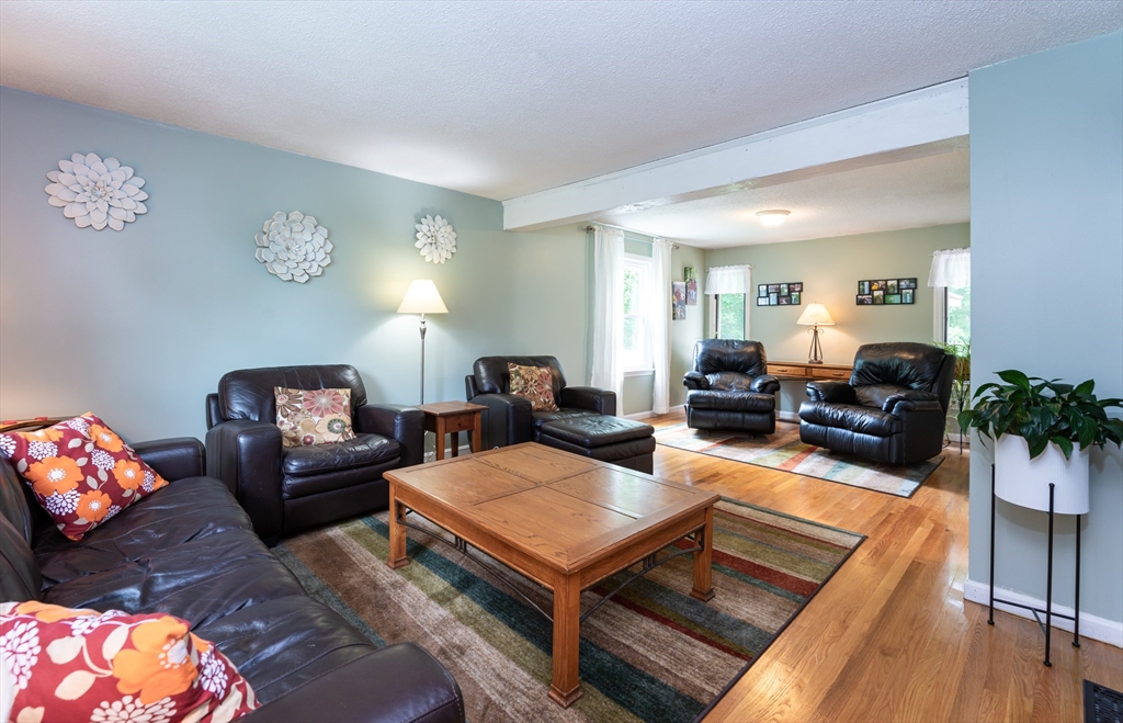 11 Emerson Road Nashua, NH 03062 - Photo 3 of 35 a living room with furniture a rug and a lamp