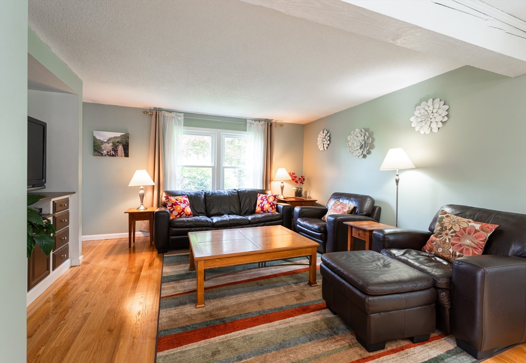 11 Emerson Road Nashua, NH 03062 - Photo 4 of 35 a living room with furniture and a flat screen tv