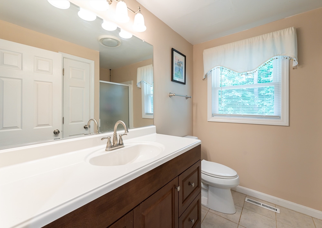 11 Emerson Road Nashua, NH 03062 - Photo 7 of 35 a bathroom with a sink a toilet and a mirror