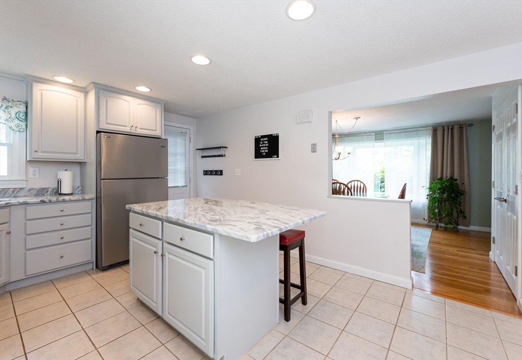 11 Emerson Road Nashua, NH 03062 - Photo 9 of 35 a kitchen that has a lot of cabinets in it and wooden floor