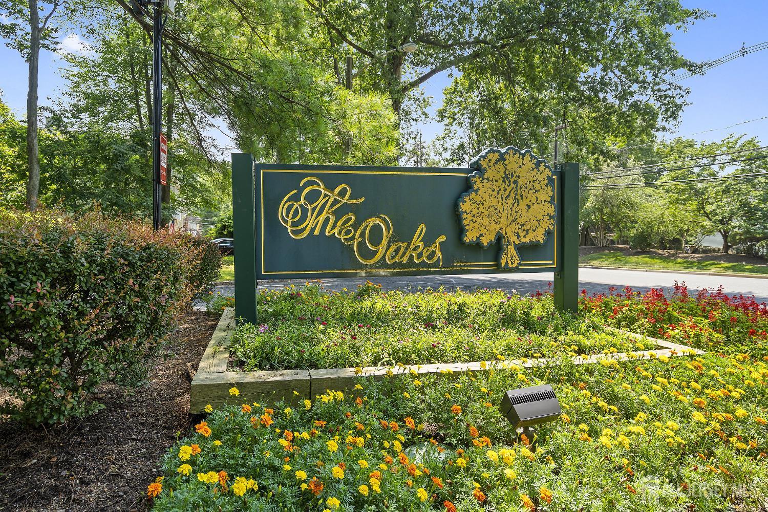 804 Timber Oaks Road Edison, NJ 08820 - Photo 2 of 26 a sign that is sitting in the middle of garden