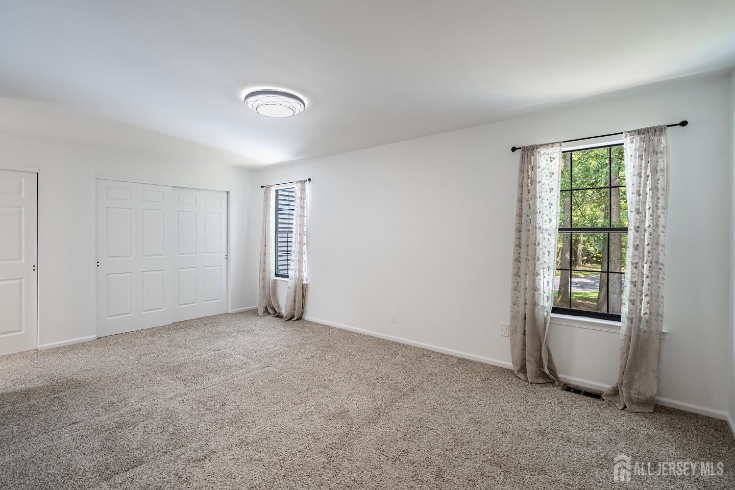 804 Timber Oaks Road Edison, NJ 08820 - Photo 22 of 26 an empty room with a window and a kitchen