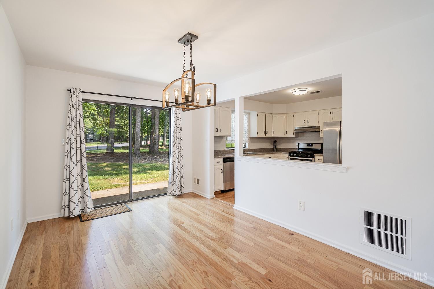 804 Timber Oaks Road Edison, NJ 08820 - Photo 8 of 26 a view of a room with wooden floor and an entryway