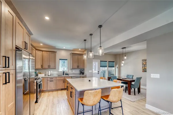 a large kitchen with a table and chairs