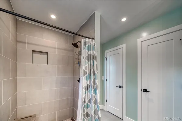 a bathroom with a shower and a glass door