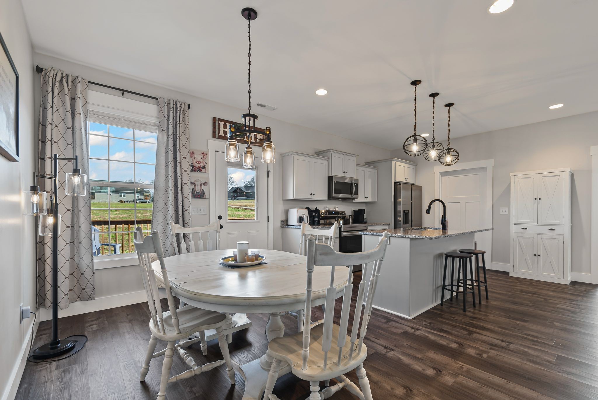 2713 Mc Connell Road Cornersville, TN 37047 - Photo 13 of 31 a view of a dining room and livingroom with furniture wooden floor a chandelier