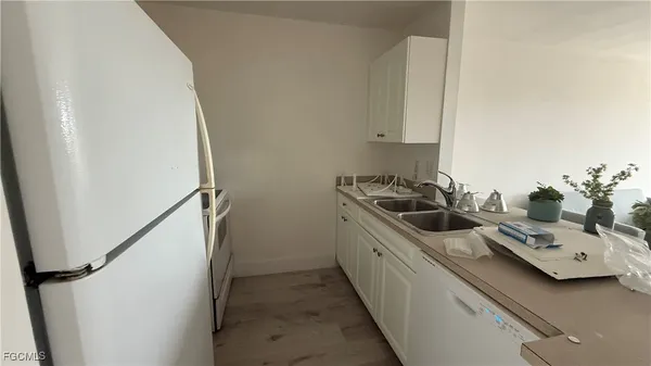 a kitchen with stainless steel appliances a sink a stove and refrigerator