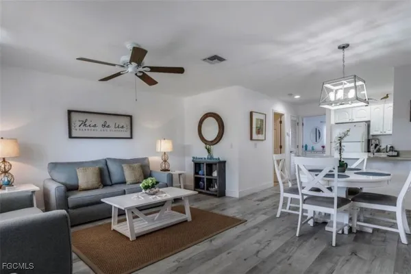 a view of a dining room with furniture and wooden floor