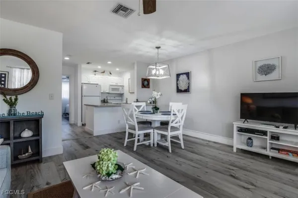 a view of a dining room with furniture window and wooden floor